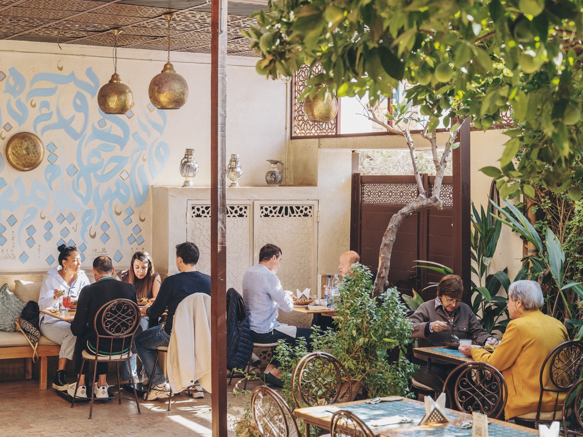 Guests dining in the courtyard at Amal Gueliz